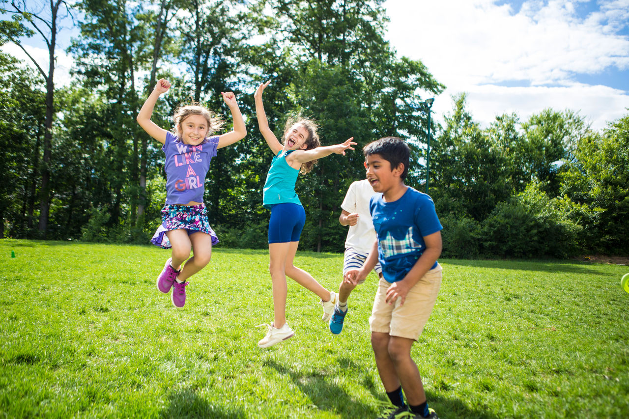 Children cheering and jumping outside